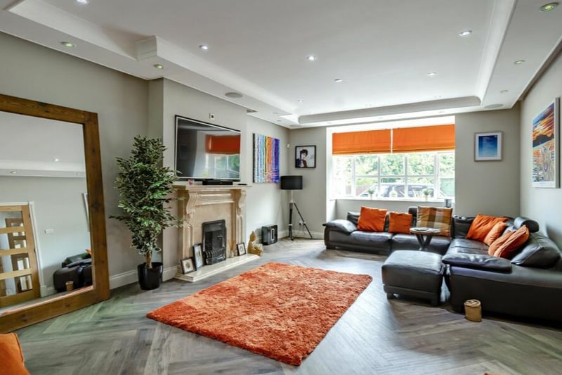 There are multiple reception rooms, including this spacious living room.