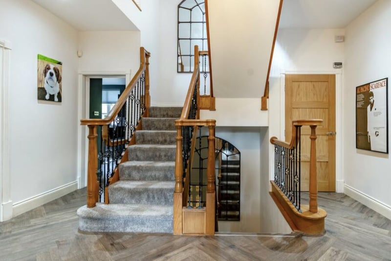 The property features a grand hallway, with parquet flooring.