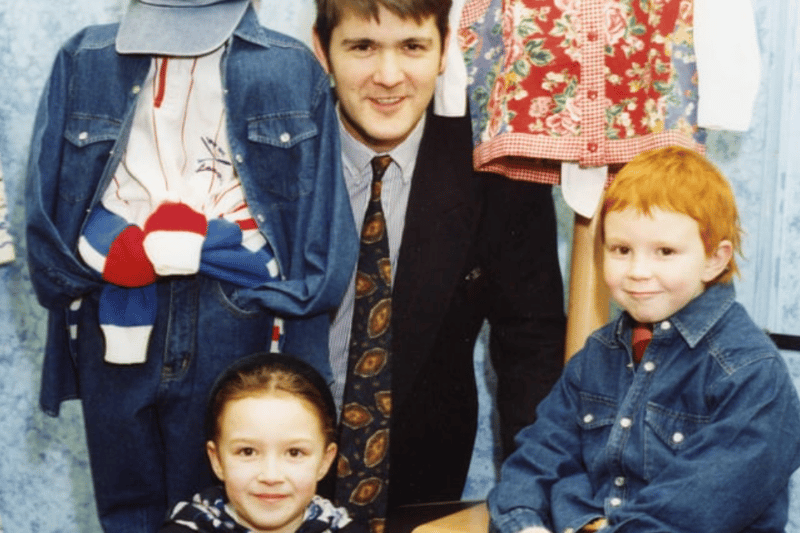 Brother and sister Harry and Rebecca Klein were the winners of a Binns colouring competition. Here they are receiving their prizes from Binns manager, Neil Setterfield in March 1994. Photo: sg