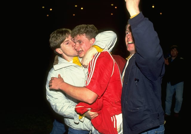 Mark Robins celebrates with a supporter after victory in the FA Cup semi-final replay against Oldham at Maine Road back in 1990