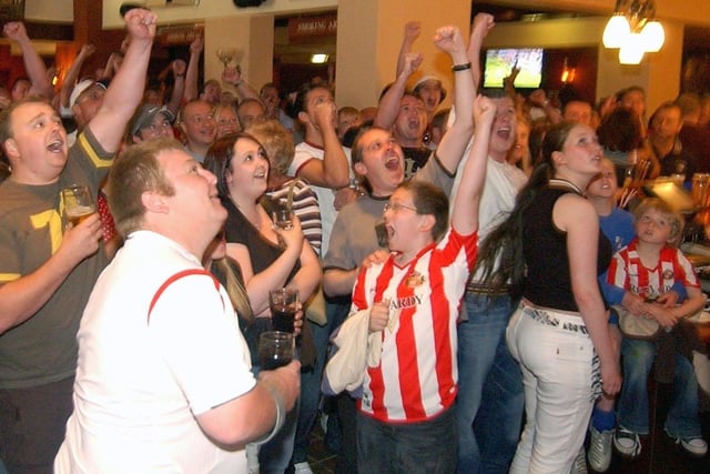These England fans watched the Three Lions beat Paraguay in the 2006 World Cup.

But the young lad on the right is taking it all in his stride.