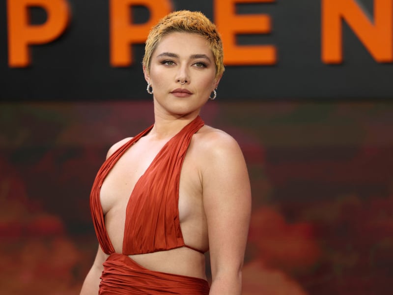 British actor Florence Pugh poses for photos on the red carpet.