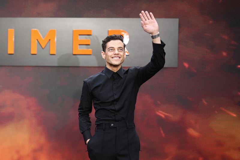 American actor Rami Malek says hello to waiting fans at the Oppenheimer premiere.