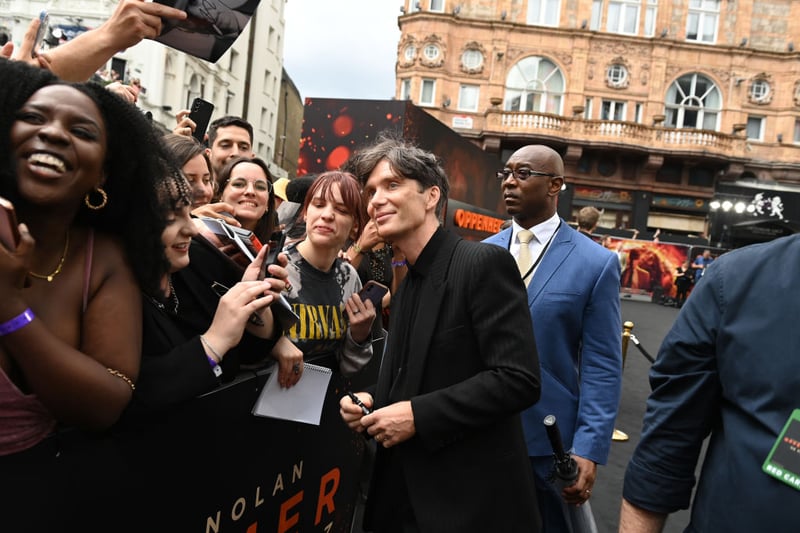 Cillian Murphy takes a photo with a fan at the UK Premiere of "Oppenheimer" at Odeon Luxe Leicester Square. (Photo by Kate Green/Getty Images for Universal Pictures)