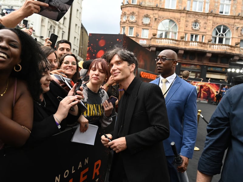 Cillian Murphy takes a photo with a fan at the UK Premiere of "Oppenheimer" at Odeon Luxe Leicester Square. (Photo by Kate Green/Getty Images for Universal Pictures)