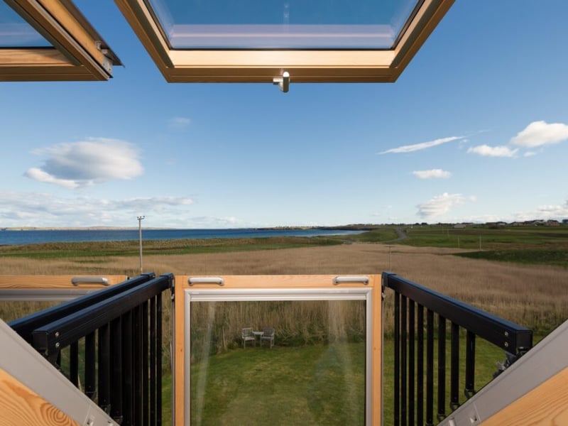 The balcony has glorious coastal views.