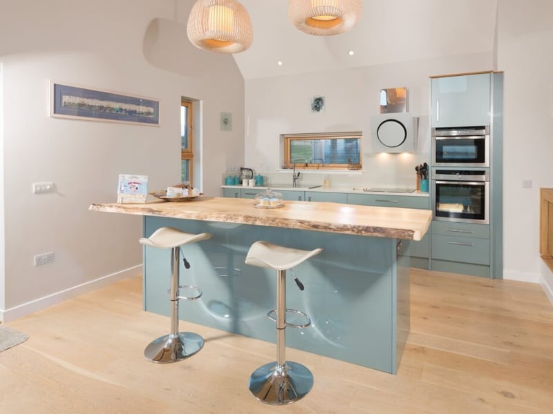 The well-equipped kitchen features a breakfast bar.