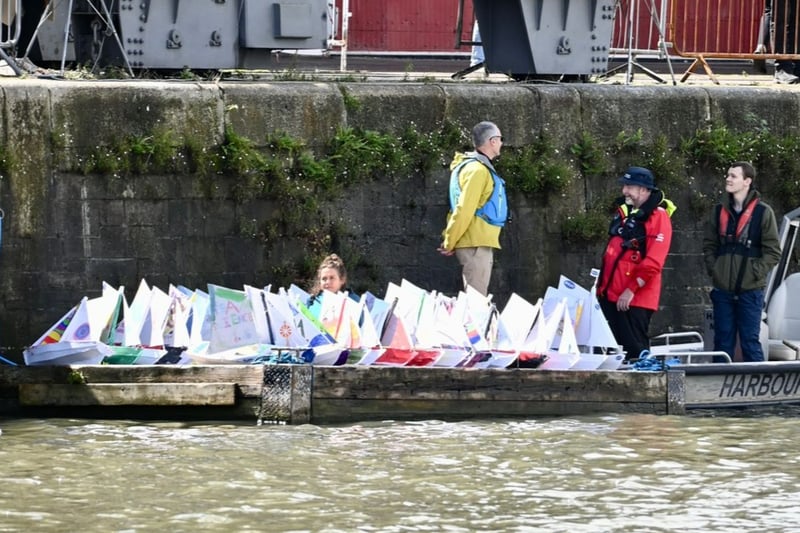 Model boats made by local primary school children line up in the Floating Harbour for the Young Shipwrights Boat Race