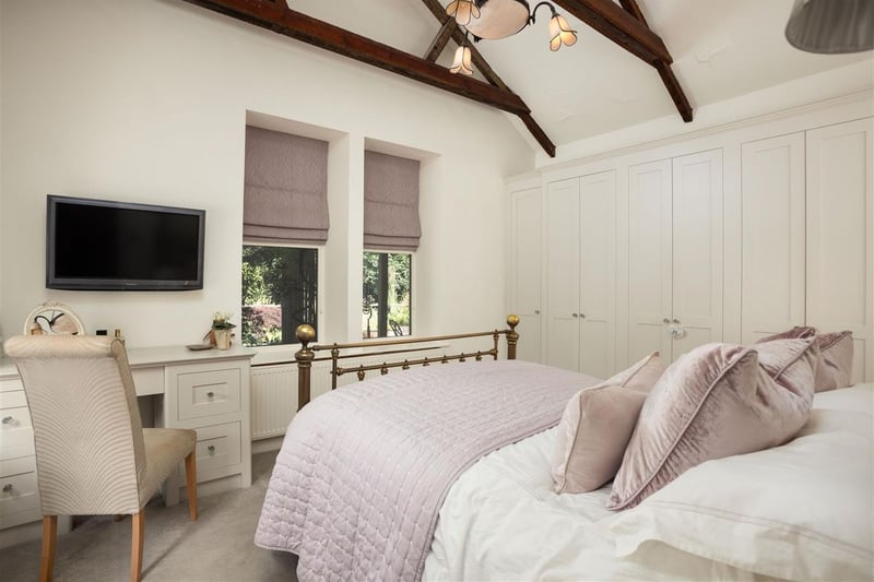 The main bedroom features fitted wardrobes and exposed beams. (Photo by Monroe Estate Agents)