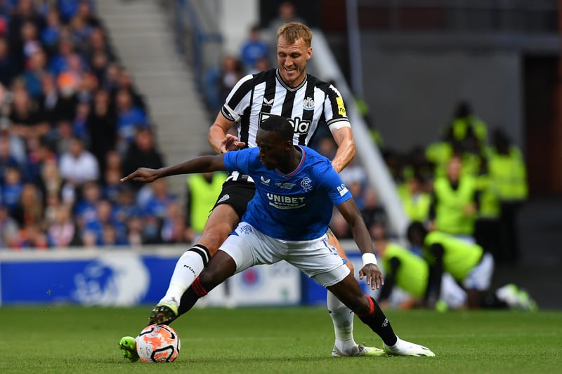 Dan Burn of Newcastle challenges Rangers loanee Abdallah Sima during the closing stages of the contest.