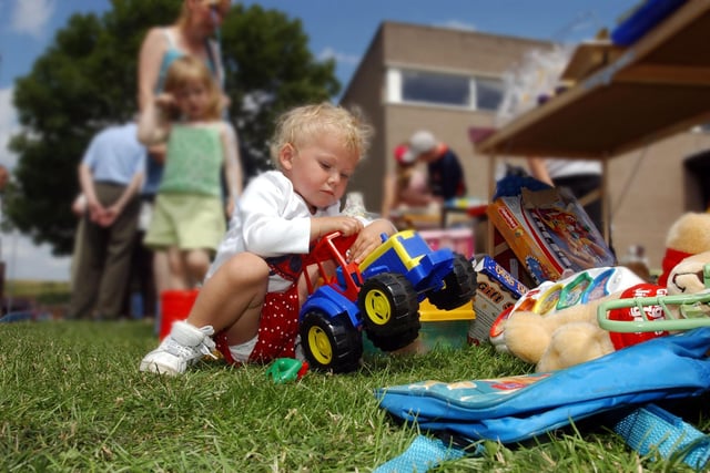 There was a tombola table just above but this toddler was happy to play with the toys under the table at the Town End Farm Carnival in 2003.