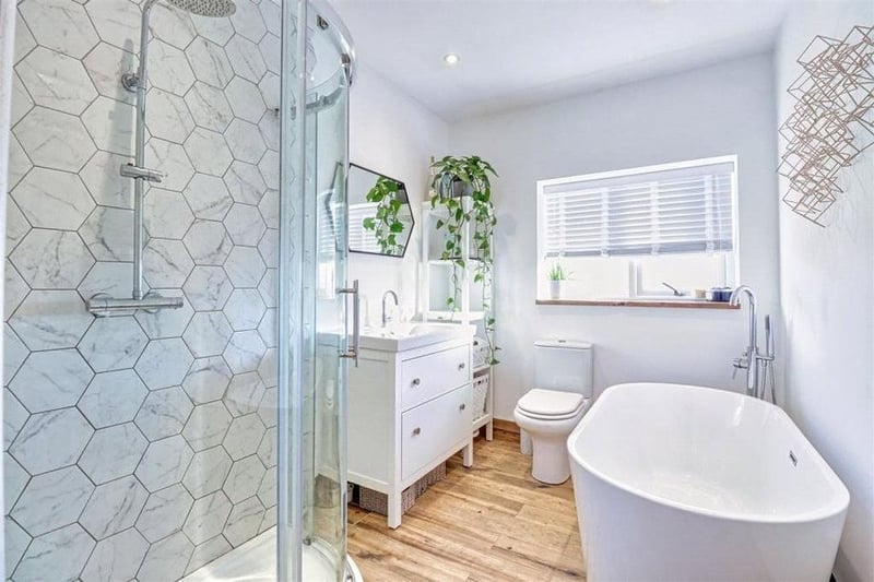 The roomy family bathroom with bathtub and shower. Photo by Manning Stainton