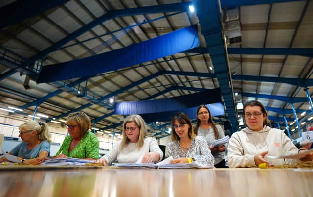 Tellers sort ballot papers at the Bath & West Showground in Shepton Mallet, Somerset, as counting begins in the Somerton and Frome by-election. Credit: PA