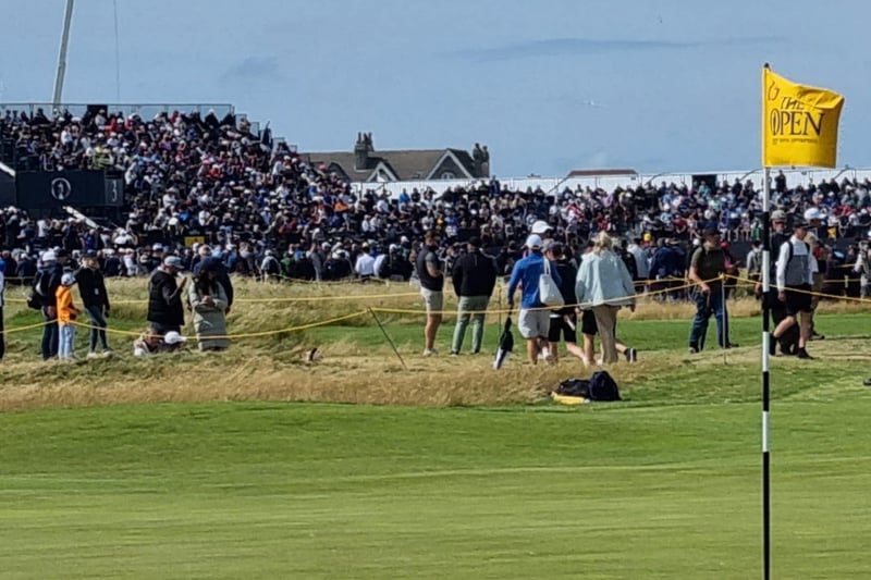 The crowd gather at the third hole.