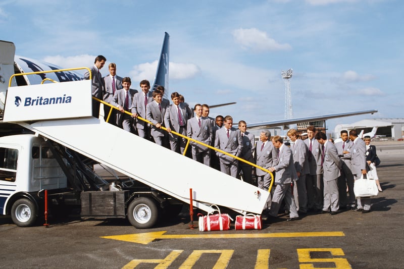 The England squad pose in their double breasted suits on the steps prior to leaving for Italy for the 1990 FIFA World Cup. Among those pictured are manager Bobby Robson (seventh right) talking to Paul Gascoigne at Luton Airport.  (Photo by Dan Smith/Allsport/Getty Images)