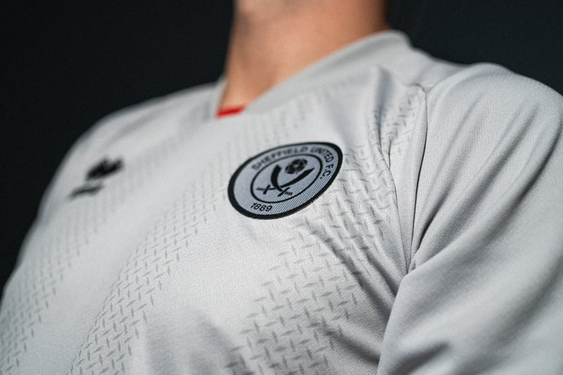 The new shirt features a monochrome badge 