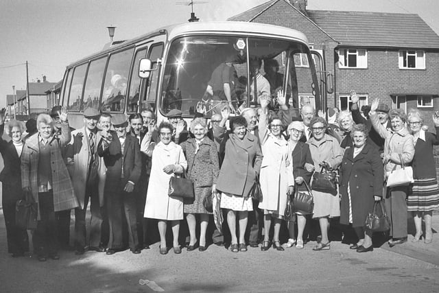 Some of the 160 pensioners give a cheery wave before leaving Hylton Castle Workingmen's Club for a trip to Knaresborough in 1979.