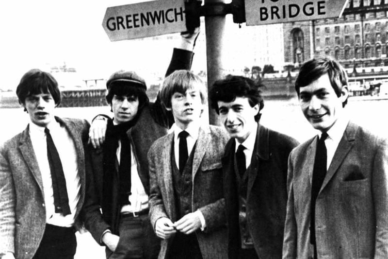 The Rolling Stones poses beneath a sign for Greenwich and Tower Bridge Streets in London, England, circa 1963. L-R: Mick Jagger, Keith Richards, Brian Jones (1942 - 1969), Bill Wyman and Charlie Watts. (Photo by Hulton Archive/Getty Images)