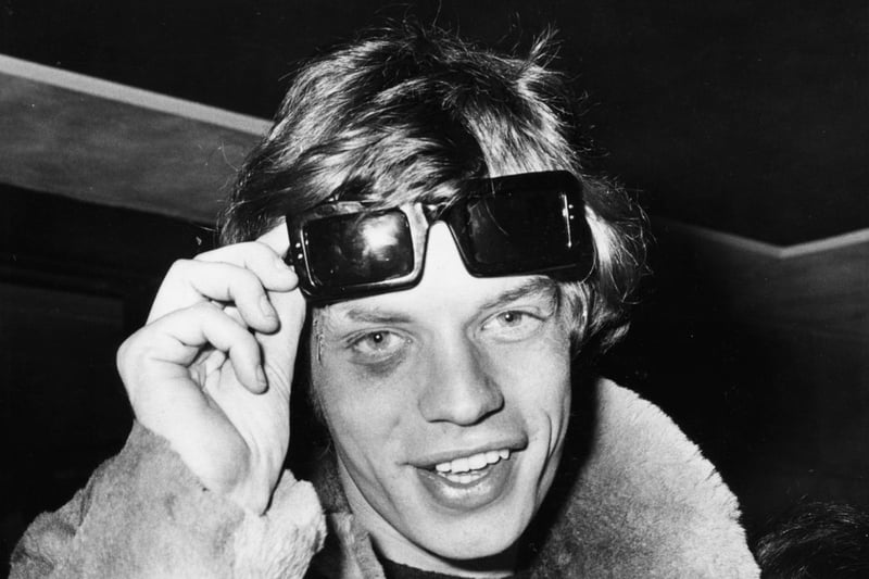 'The Rolling Stones' lead singer Mick Jagger lifting up his sunglasses to reveal a black eye, which he received on tour in France, as he signs autographs for fans at London Airport, April 6th 1966