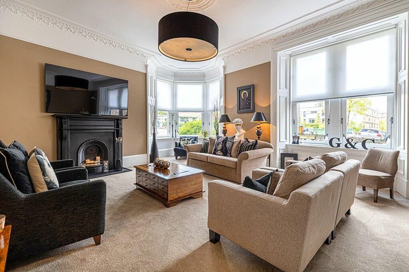Sitting room/bedroom four with aspects onto Partickhill Road and complete with ceiling cornice, ceiling rose, focal point fire surround with tiled hearth, and luxury carpet floor coverings