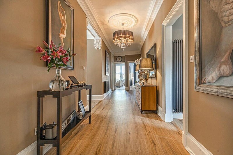 After entering via double storm doors to a tiled vestibule, you’re greeted with this view of the 37ft reception hallway,