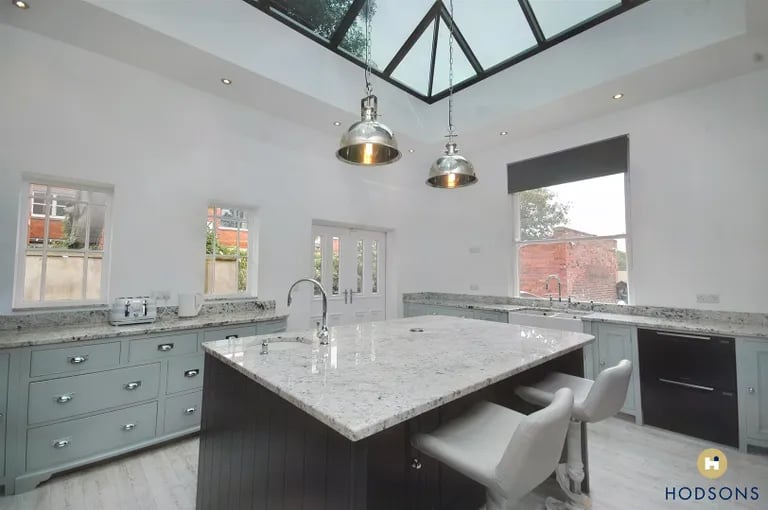 The modern and bright kitchen extension features glass roof lantern. Picture by Hodsons