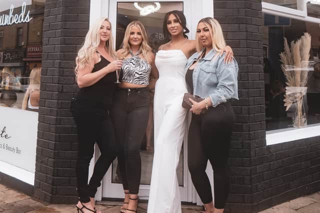 Laura Caine (in white) pictured with three of her four staff outside Ellite Beauty Bar.
