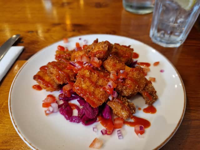 Pictured is the ‘crispy panko salmon bites' starter, with tomato salsa, pickled cabbage and sriracha.