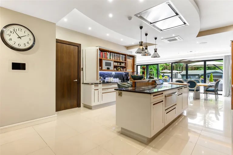 The rear garden is accessed via large glass doors. Picture by Fine & Country