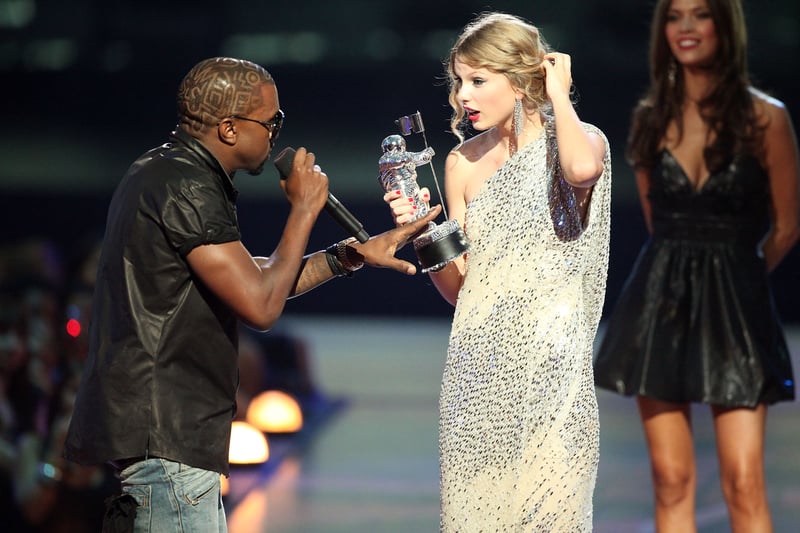 NEW YORK - SEPTEMBER 13:   Kanye West (L) jumps onstage after Taylor Swift (C) won the “Best Female Video” award during the 2009 MTV Video Music Awards at Radio City Music Hall on September 13, 2009 in New York City.  (Photo by Christopher Polk/Getty Images)