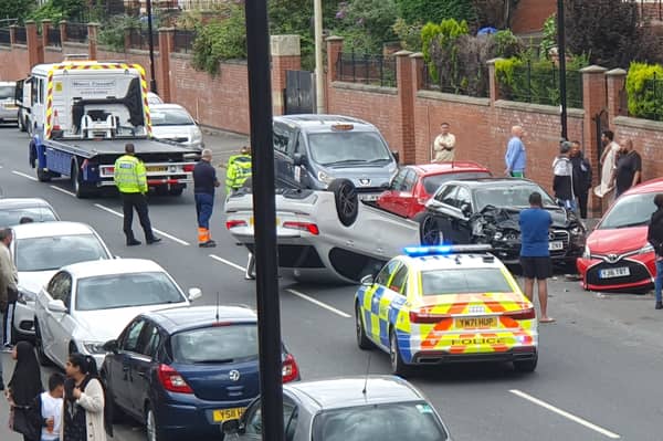 Firth Park Road was closed while emergency services dealt with a serious crash which saw a car end up on its roof