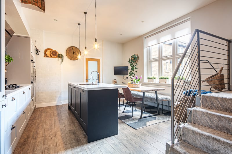 The kitchen shares a ground floor space with a dining table.