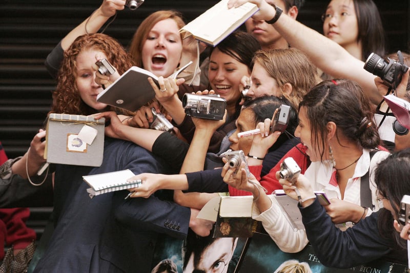 Rupert Grint is hugged by fans as he arrives in London’s Leicester Square for the European Premiere of his latest film Harry Potter and the Order of the Phoenix on July 3 2007. (Photo by SHAUN CURRY/AFP via Getty Images)