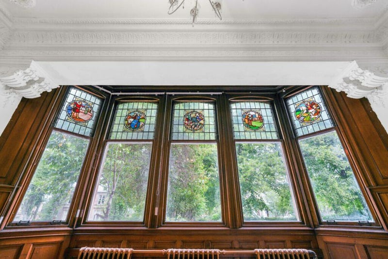 The windows have a stained glass crown in the property