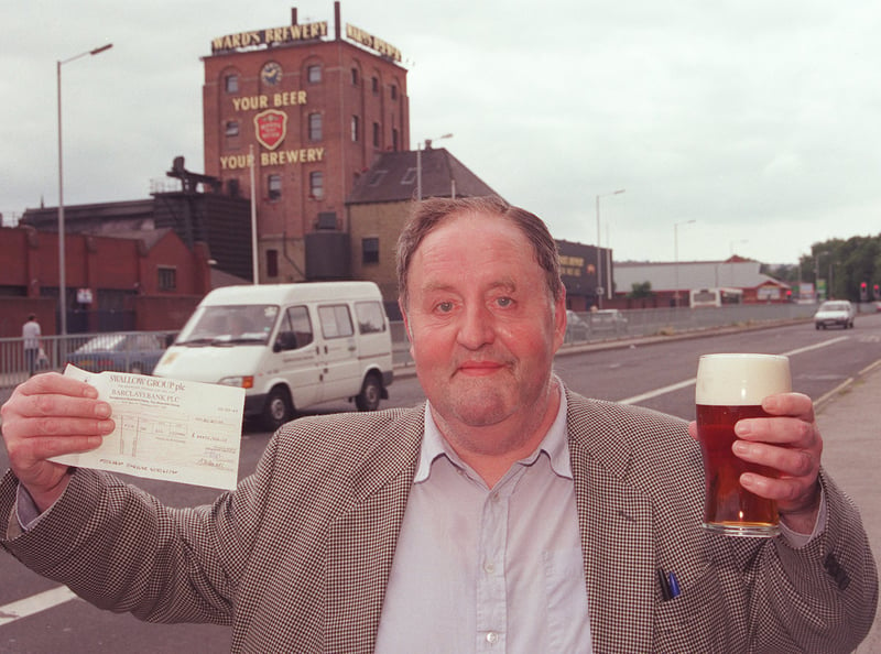 Wards Brewery worker Graham White pictured with his final pay cheque and a pint at the Norfolk Arms pub on Ecclesall Road, Sheffield, with the brewery in the background.
