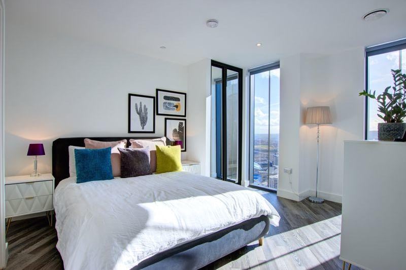 The apartment features three bedrooms, all with views of the city.