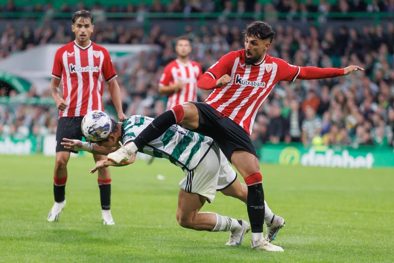 Hyeongyu Oh of Celtic finds himself in an awkward spot as he attempts to bravely win the ball under pressure from Benat Prados Diaz of Athletic Club.
