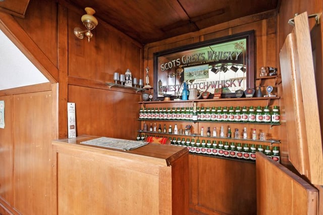 The wooden bar has a traditional feel, located in the snooker room