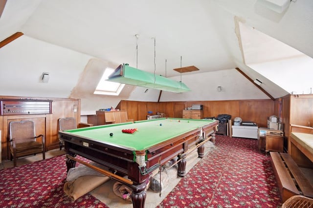 The snooker room includes a full-sized table, overhead light, and bar.