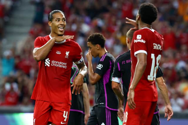 Virgil van Dijk #4 (L) of Liverpool celebrates with Cody Gakpo #18 after scoring their second goal off a header against Bayern Munich during the first half of the pre-season friendly at the National Stadium on August 02, 2023 in Singapore. (Photo by Yong Teck Lim/Getty Images)