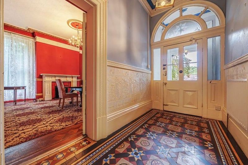 The internal door has etched glass panelling, leading to the hallway with encaustic tiled floors.