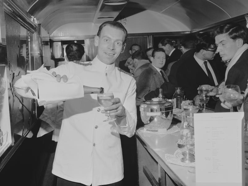 The new Nightcap Bar on the London to Glasgow overnight sleeper train with guests enjoying a refreshment in 1964.