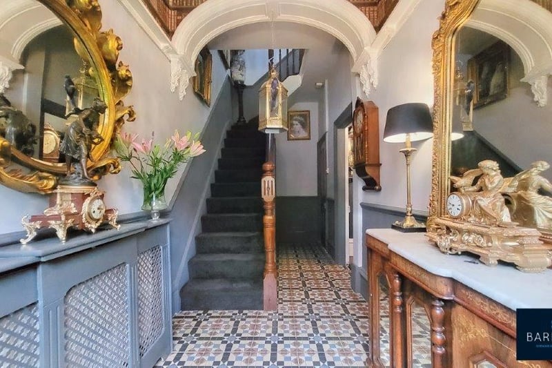 The stunning hallway with vaulted ceilings and stairs to the first floor.