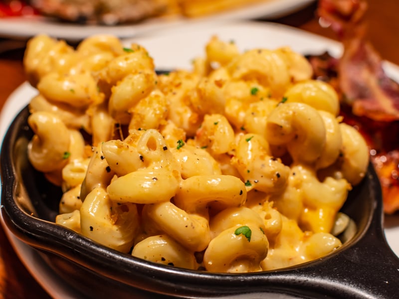 This multi-award-winning independent Jamaican restaurant makes a creamy homemage macaroni covered with a crispy cheese crust and springkled with jerk spices for a rich taste. (Photo - Chansak Joe A. - stock.adobe.com)
