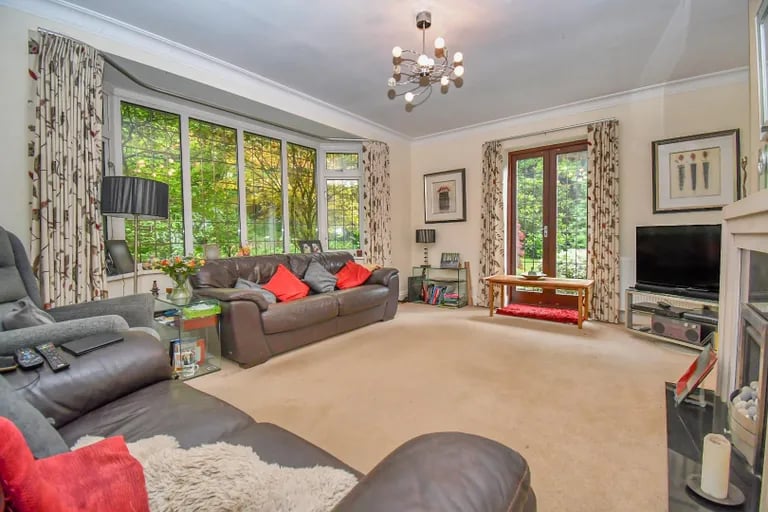 Spacious sitting room with large bay windows for lots of natural light.