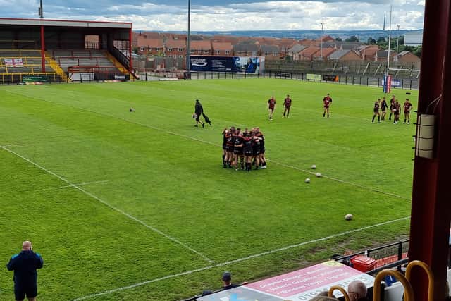 Dewsbury players in a huddle as the clock ticks down to kick off