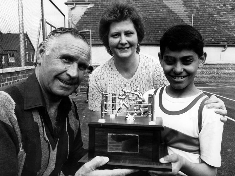 Harold Morton, of the La-Planta Social Club,presents the trophy to Naseem Hamed (13), National Schoolboy Five Stone Champion, watched by Rita Marriott, club secetary of the St. Thomas Boys Club, Wincobank. Mr Morton also presented a cheque for £200 to the club.
