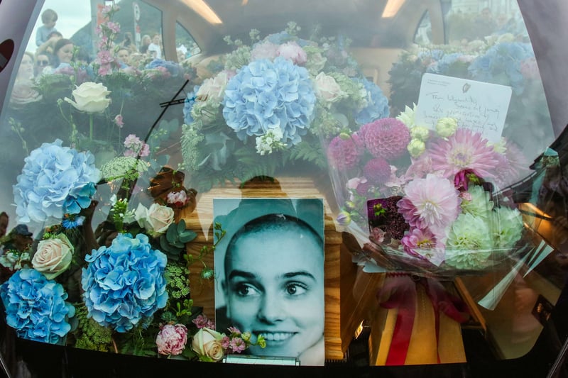 The coffin and a picture of late Irish singer Sinead O’Connor. (Photo by PAUL FAITH/AFP via Getty Images)