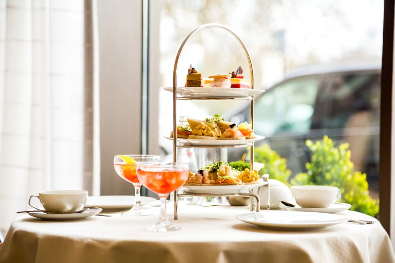 This is a stylish dining room where afternoon tea can be enjoyed under a soaring glass atrium. The Hyatt Regency restaurant offers a selection of sandwiches and desserts. It is rated 4 stars from 75 reviews. (Photo - ingusk - stock.adobe.com)
