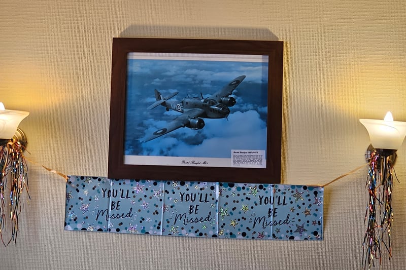 A photo of the Beaufort plane, which is where the pub's name comes from. "You'll be missed" banners have been placed below the framed photo for the farewell party."